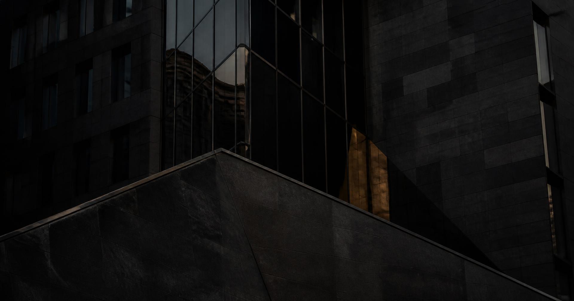 Dark stone and glass facade at night
